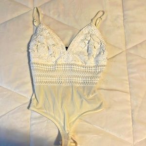 Sheer crocheted white laced bodysuit. From copper closet.